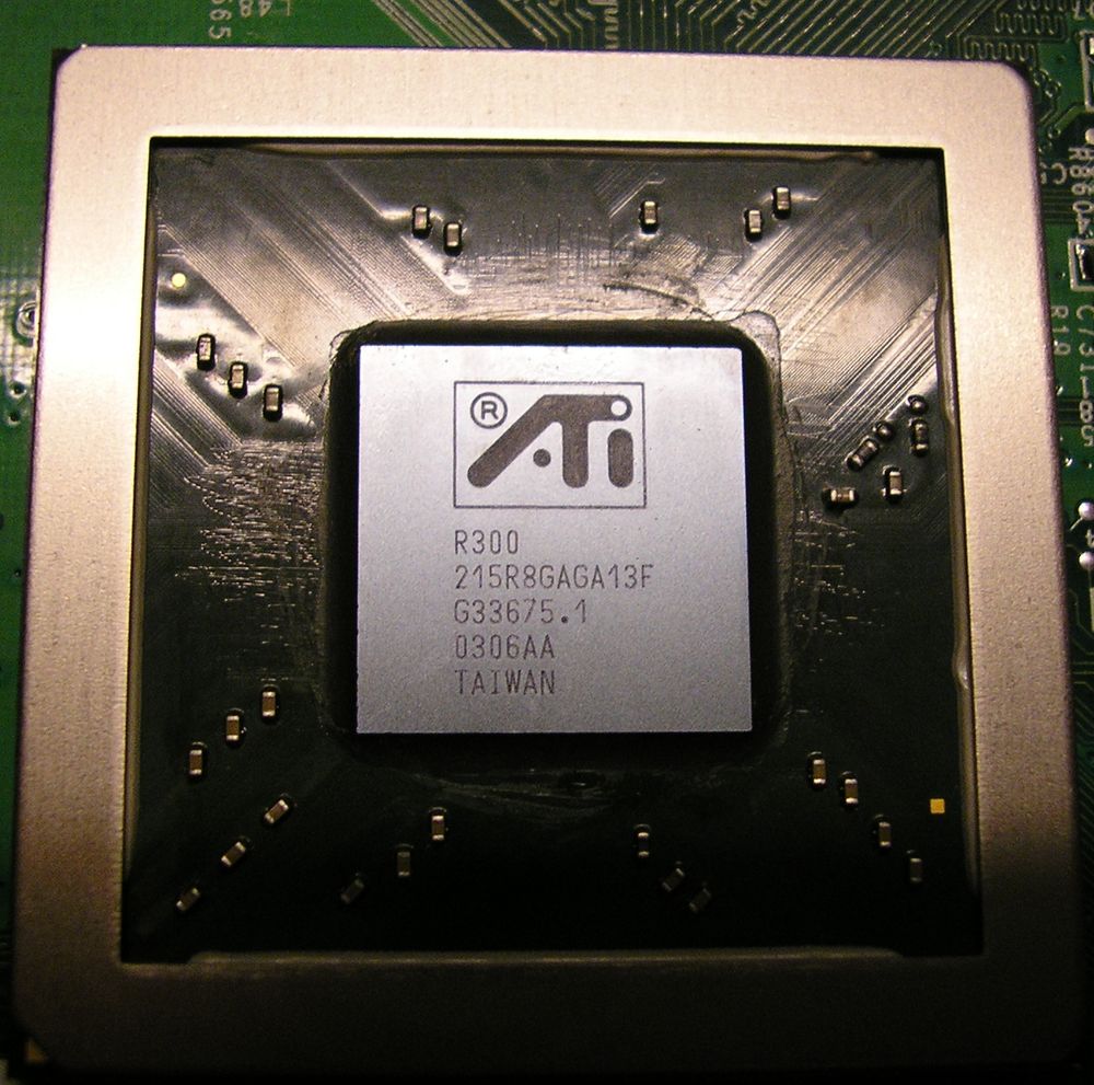 Close-up of the ATI R300 graphics chip: a silver square die carrier with the ATI logo and the marking R300, set in a black package with a metal frame around it