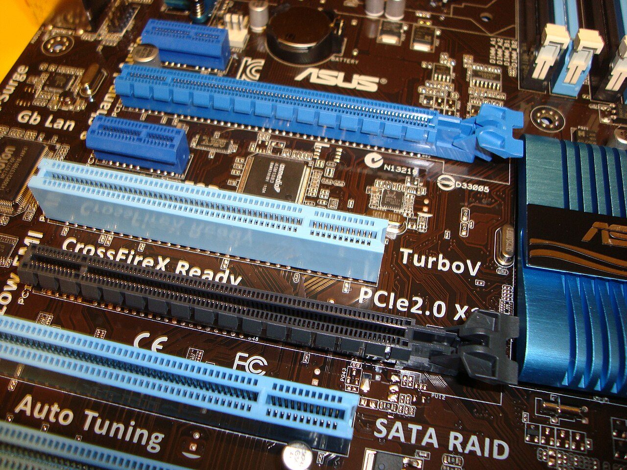 Close-up of a desktop motherboard with several expansion slots of different lengths, labelled PCIe 2.0 x16